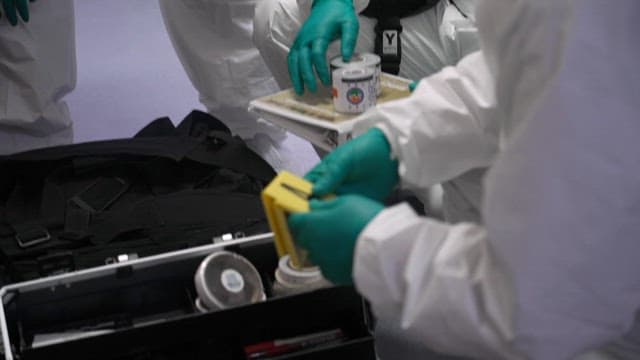 Forensic scientists handling research equipment