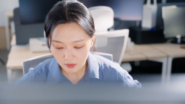 Focused woman working at her desk