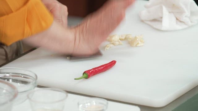 Chopping Garlic on a White Cutting Board