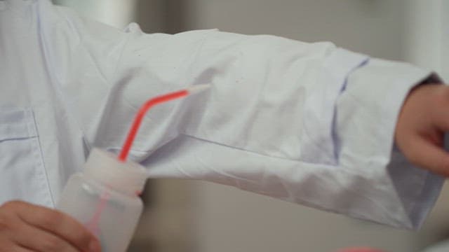 Person in a lab coat performing a waterproof experiment