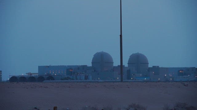 Distant view of a nuclear power plant at dusk
