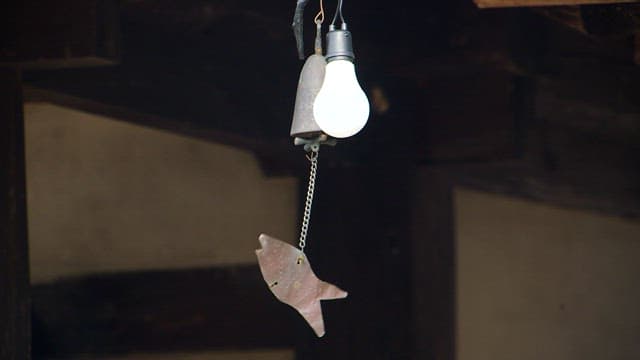Hanging light bulb and metal wind chime