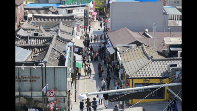 Bustling traditional market street with many people