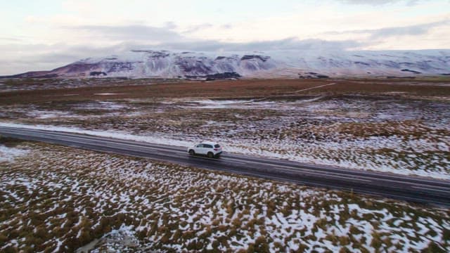 Car driving through a snowy landscape