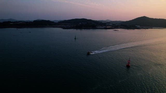 Serene Sunset Over Coastal Waters with Boat