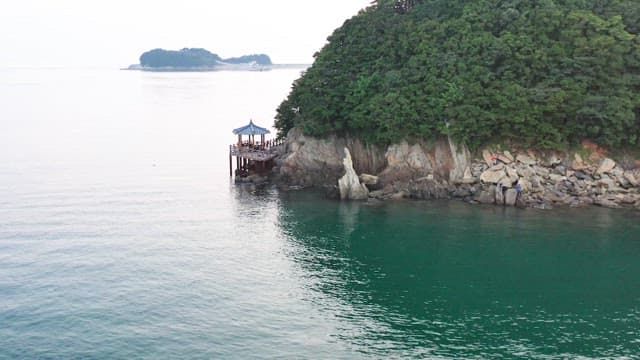 Traditional Korean pavilion located on a peaceful seaside cliff