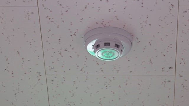 Ceiling-mounted smoke detector in smoky room