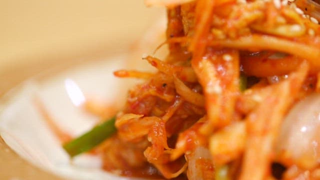Crisp and spicy cabbage kimchi sprinkled with sesame seeds