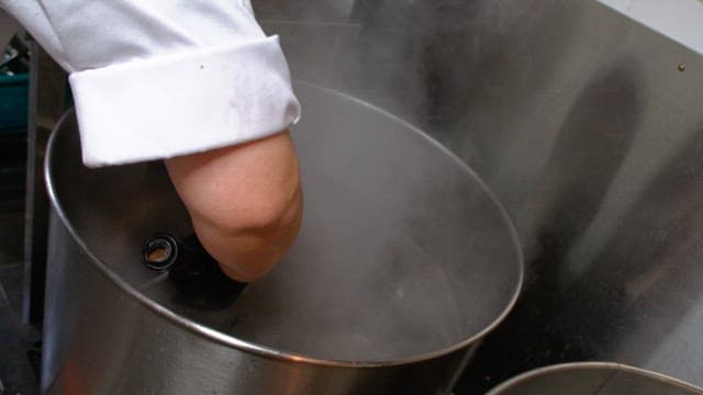 Rinsing boiled pig's feet and meat in water in the kitchen