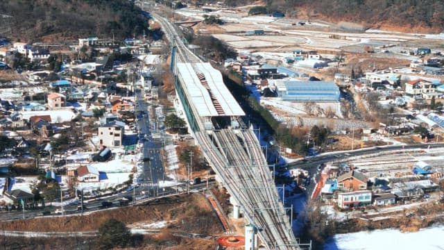 Snowy Town with Train Station and Tracks