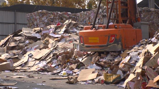 Recycling center with piles of compressed recyclable paper