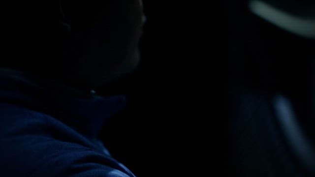 Person Shaking His Head in a Dark Room