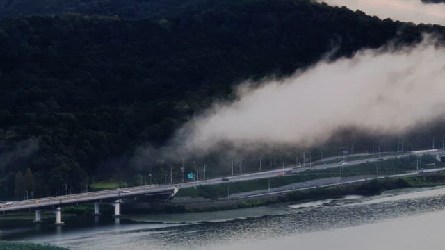Fog rolling over a mountain and highway