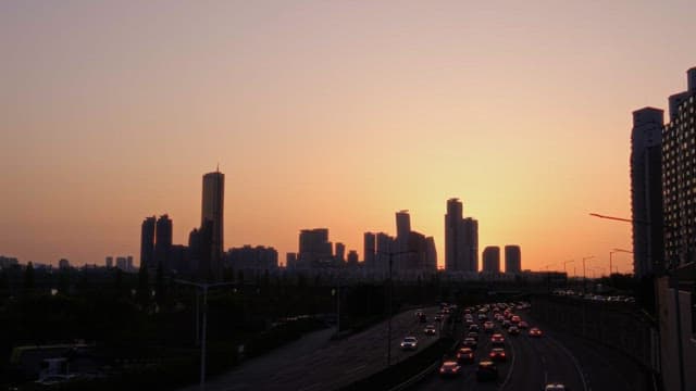 Sunset over the bustling city highway