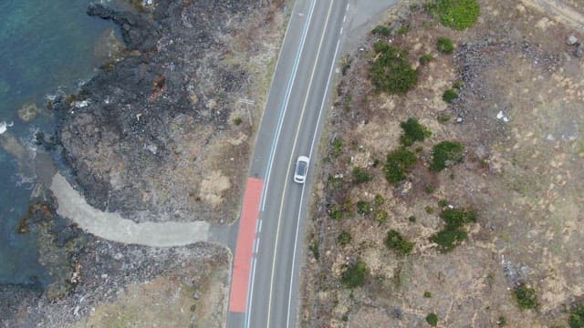 Car driving along a coastal road