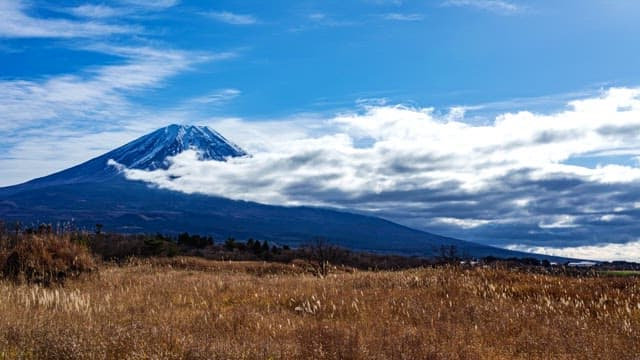 Majestic Mount Fuji with clouds and fields