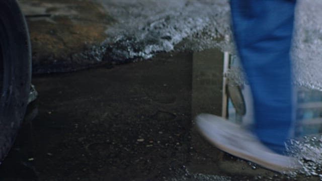 Person Entering a Container in a Space Where Taxis are Parked