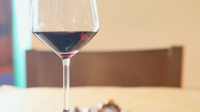 Close-up of wine glass and gourmet food on table