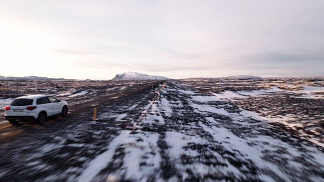 Car driving through a snowy landscape