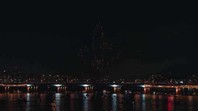 Fireworks over a city bridge at night