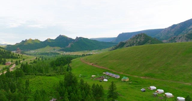 Green hills and mountains with distant village