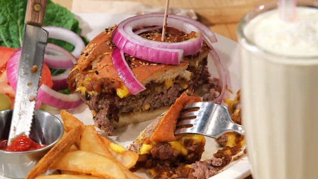 Bite of juicy burger with ketchup