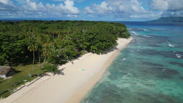 Beach with emerald water and huts