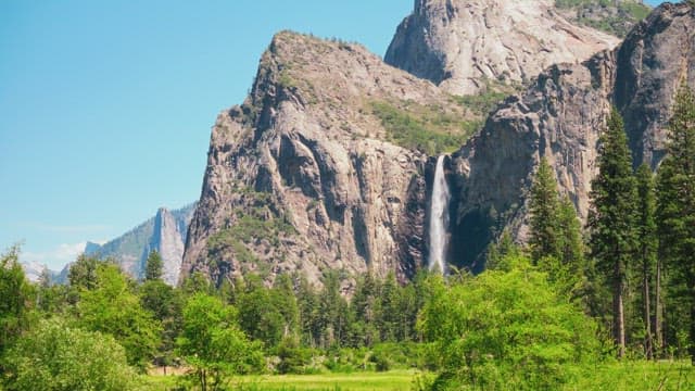 Majestic Waterfall in a Verdant Mountain Valley
