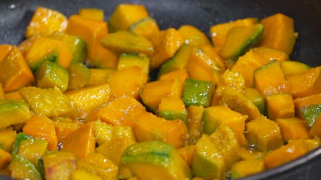 Stir-frying Diced Pumpkin in a Hot Skillet