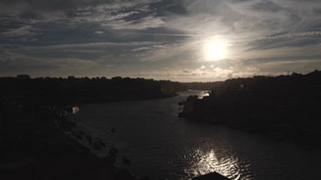 Sunset Sky with Clouds and Silhouette of Riverside city