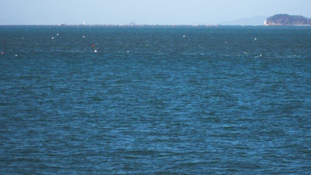Fishing boat cruising on a calm sea under a clear sky