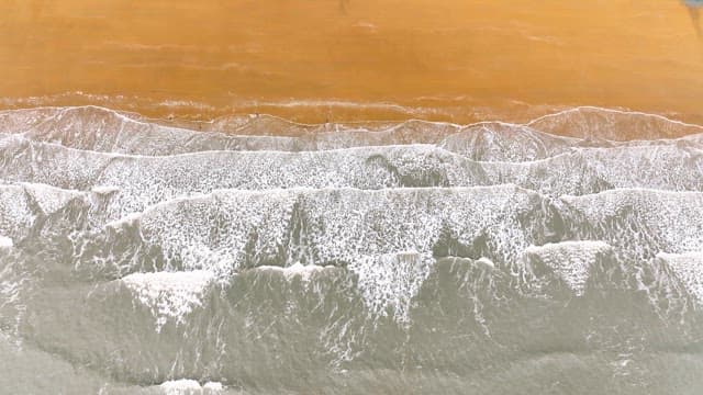 Waves gently crashing on a sandy beach