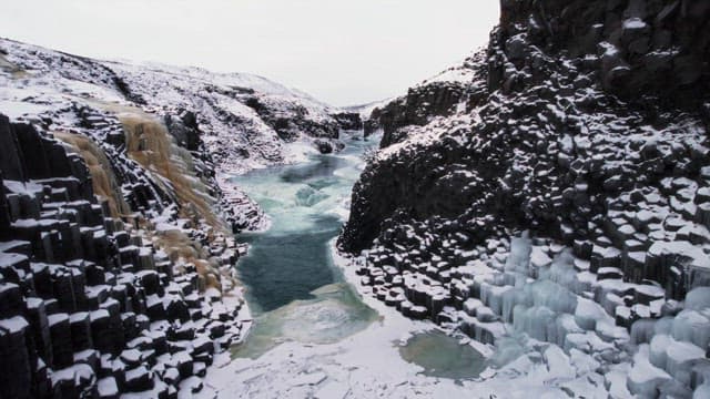 Snow-covered canyon with a frozen river
