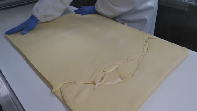 Kneading a large batch of dough in a commercial kitchen