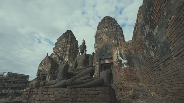 Monkeys Climbing on a Large Buddha Statue in an Ancient Temple