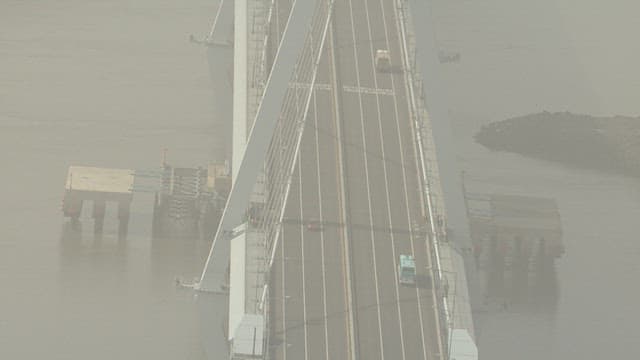 Aerial View of Traffic on a Hazy Bridge