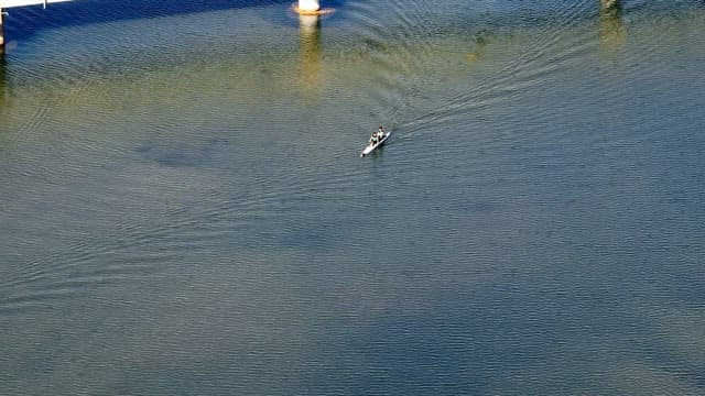 Two people kayaking on a calm river