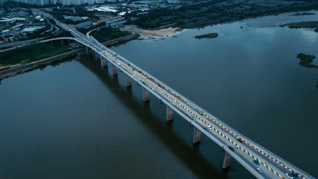 Bridge over a river with cityscape