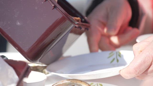 Mushroom side dish being served on a plate at an outdoor table