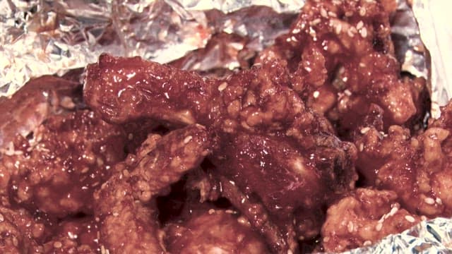 Bite of crispy, moist, and sweet and spicy seasoned chicken