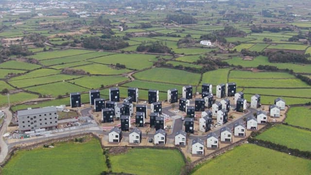 Rural village surrounded by green fields