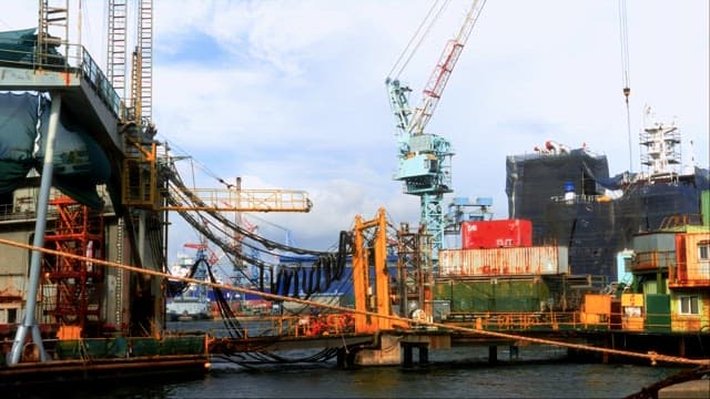 Shipyard with Cranes and Docked Vessel