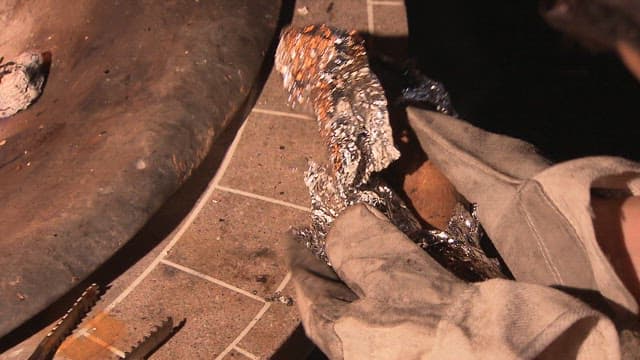 Peeling a sweet potato wrapped in foil