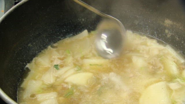 Korean radish soup being served in a bowl
