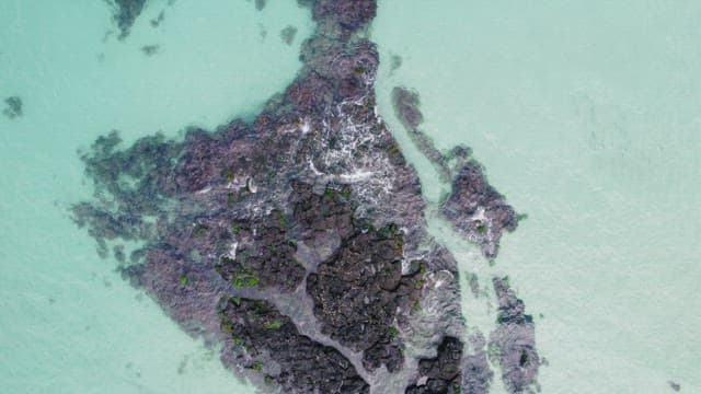 Rocky formations in clear turquoise water
