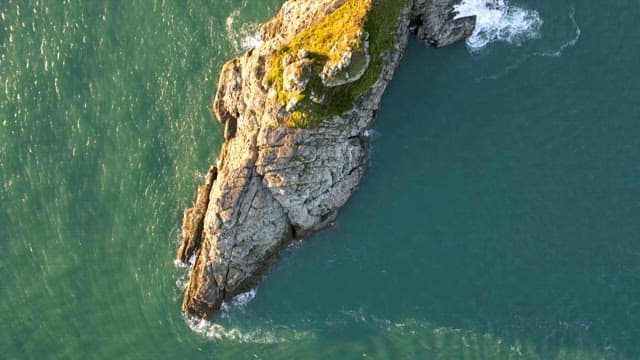 Rocky island surrounded by ocean waves