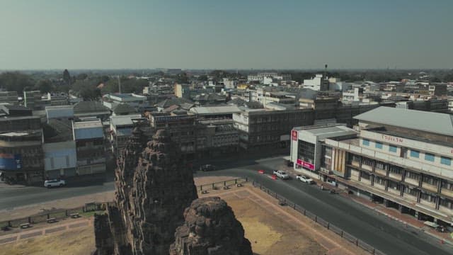 Overview of a Bustling Street with Ancient Temple Ruins