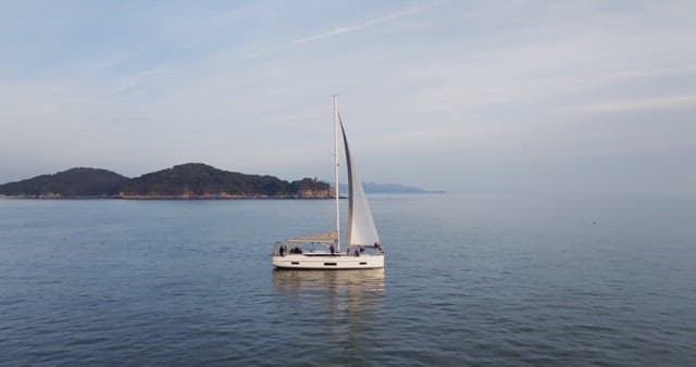 Yacht sailing near a coastal town