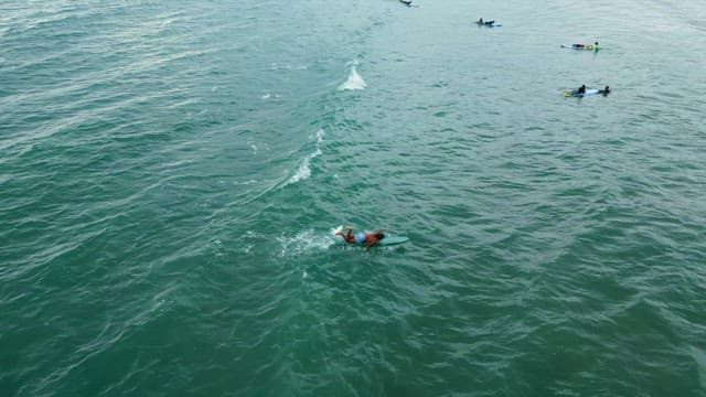 Surfers riding waves in the ocean