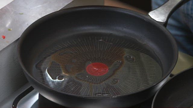 Putting the perilla leaf pancakes on a hot oiled pan